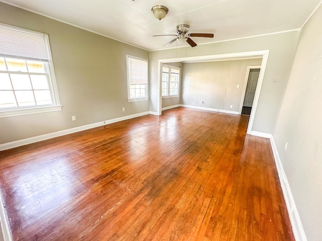 spare room featuring ceiling fan, wood-type flooring, and ornamental molding