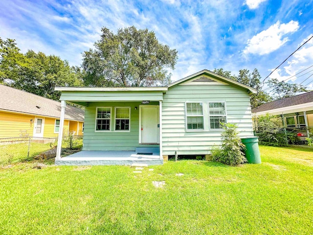 rear view of property featuring a yard