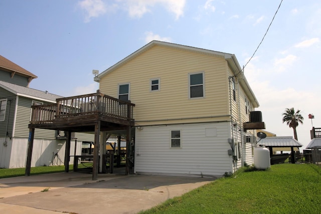 rear view of property with a yard, a deck, and central AC unit