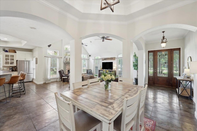 8185 Dawn Dr, Beaumont, TX 77705 - dining space with a raised ceiling, arched walkways, plenty of natural light, a ceiling fan, and ornamental molding