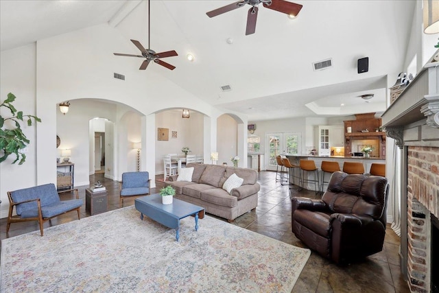8185 Dawn Dr, Beaumont, TX 77705 - living room with a ceiling fan, arched walkways, and high vaulted ceiling