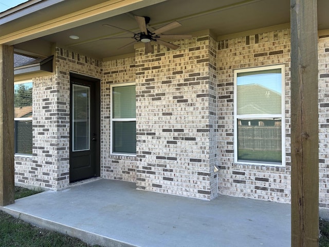 doorway to property with ceiling fan and a patio