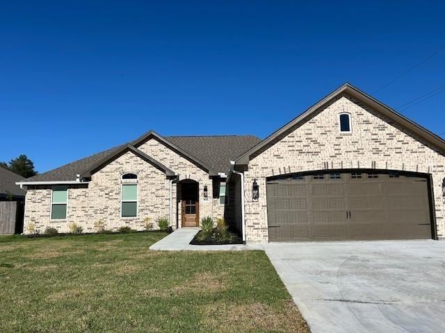 view of front of home with a front lawn and a garage