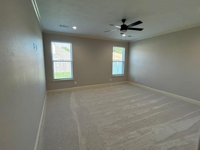 carpeted empty room with plenty of natural light, ornamental molding, and ceiling fan