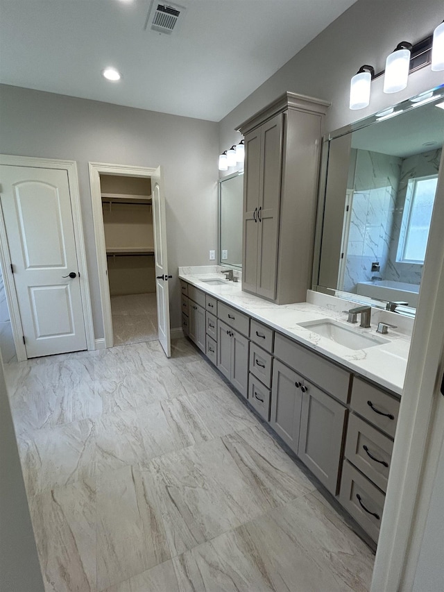 bathroom with vanity and a tub to relax in