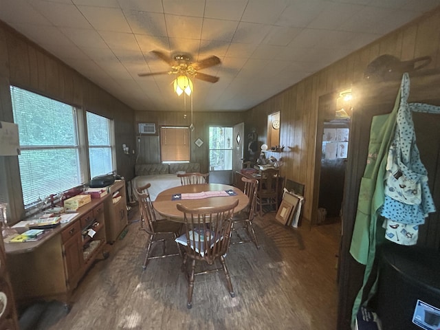 104 Hornbeam Dr, Village Mills, TX 77663 - dining space with wood finished floors, wood walls, a ceiling fan, and an AC wall unit