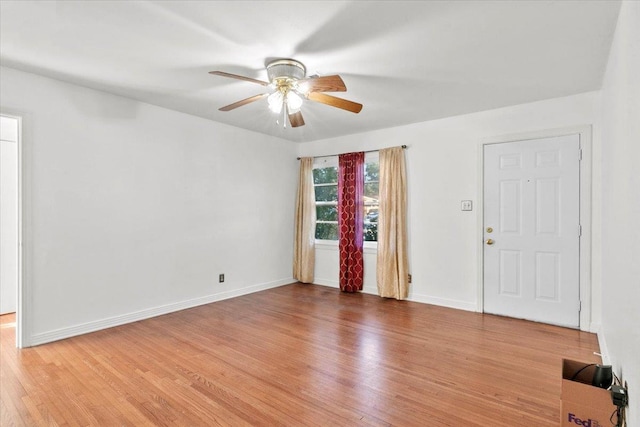 spare room with hardwood / wood-style floors and ceiling fan