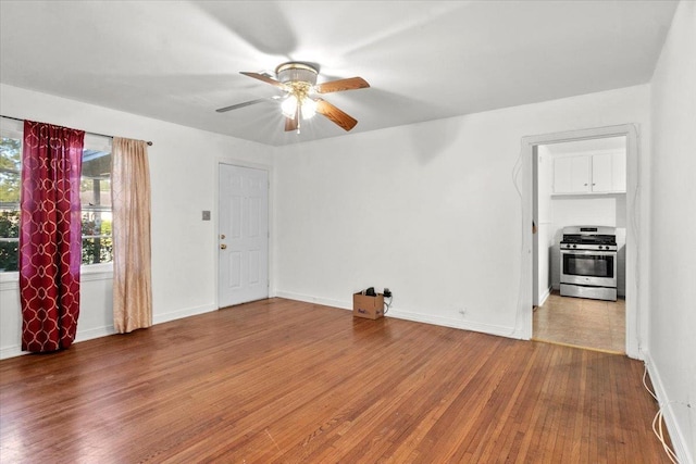 unfurnished living room with hardwood / wood-style floors and ceiling fan