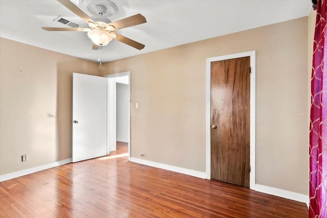 unfurnished bedroom featuring hardwood / wood-style floors and ceiling fan