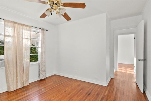 empty room with ceiling fan and light hardwood / wood-style flooring