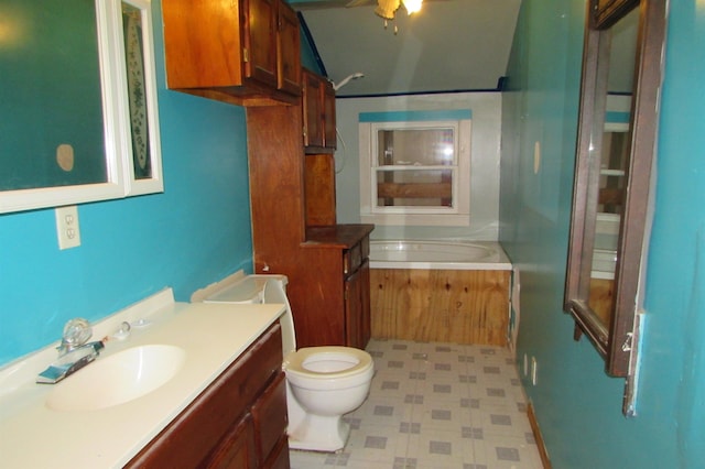 2114 11th St, Port Neches, TX 77651 - bathroom featuring toilet, vanity, a tub to relax in, ceiling fan, and tile patterned floors