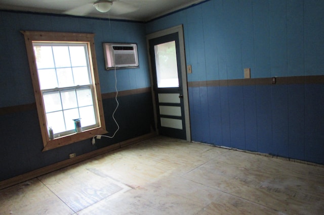 2114 11th St, Port Neches, TX 77651 - empty room featuring a ceiling fan, healthy amount of natural light, and an AC wall unit