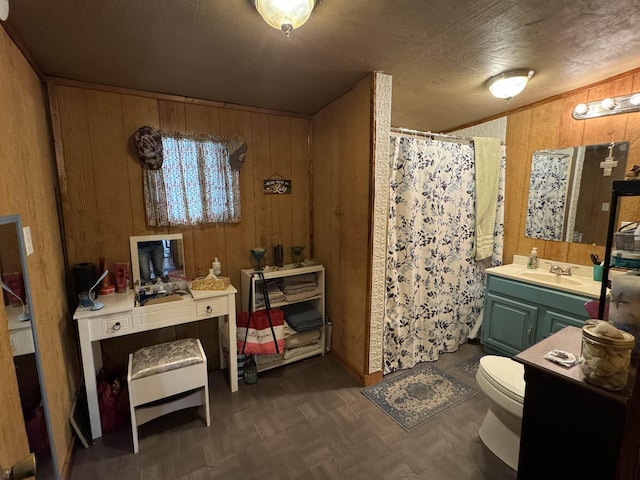 bathroom with parquet floors, toilet, wooden walls, vanity, and a shower with shower curtain