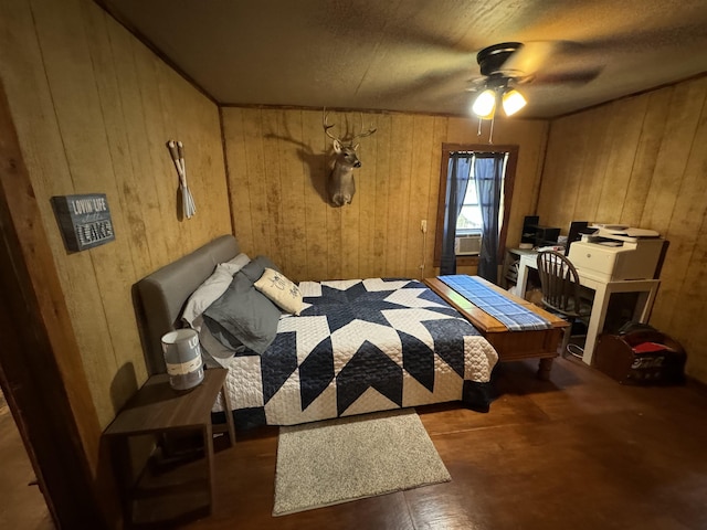 bedroom featuring ceiling fan and wooden walls