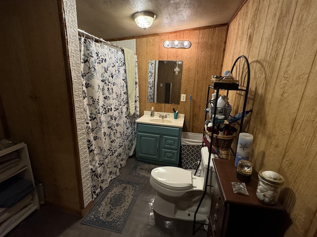 bathroom with vanity, toilet, curtained shower, and wooden walls