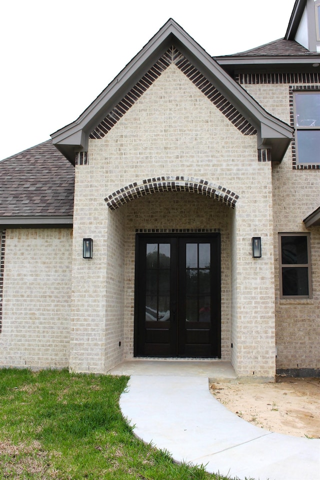 view of exterior entry featuring french doors