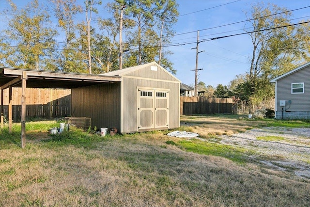 view of outbuilding featuring central air condition unit and a yard