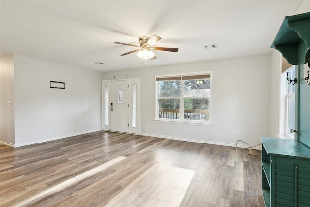 unfurnished living room with ceiling fan and light wood-type flooring