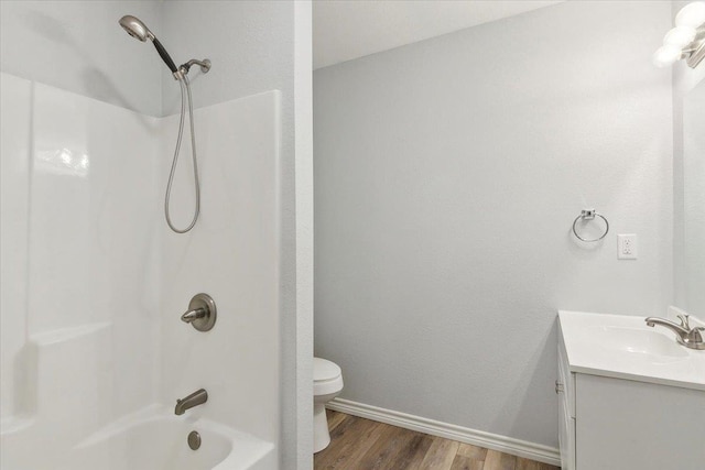 full bathroom with hardwood / wood-style flooring, toilet, vanity, and bathing tub / shower combination