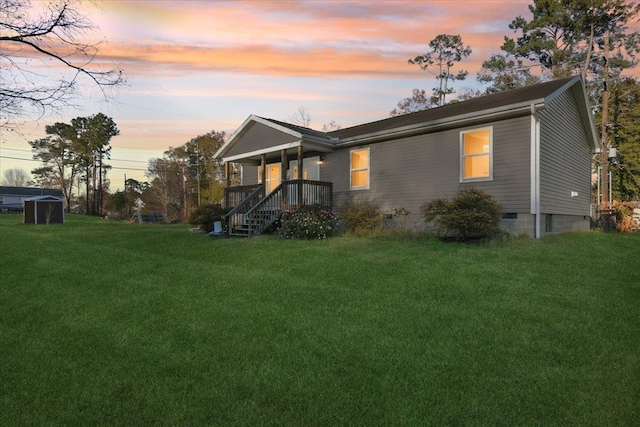 back house at dusk with a yard