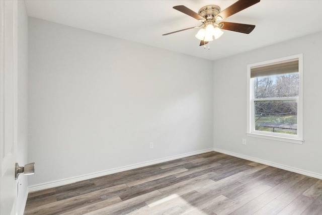 spare room featuring wood-type flooring and ceiling fan