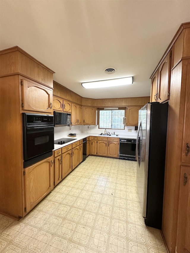 kitchen with sink and black appliances