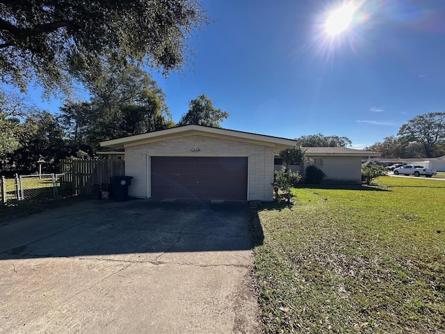 ranch-style house with a garage and a front lawn