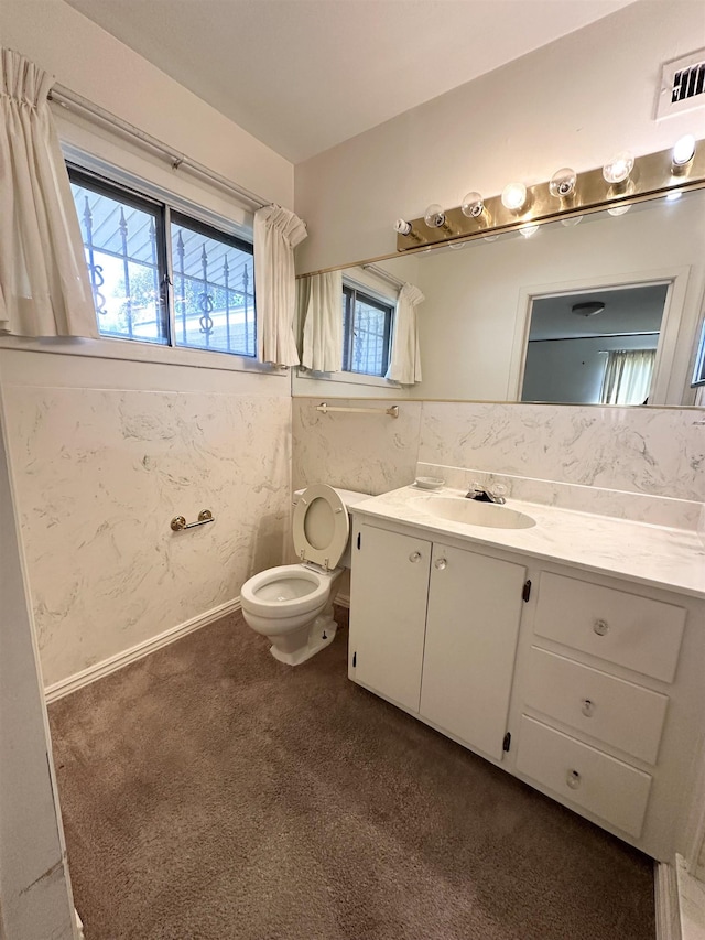 bathroom featuring vanity and toilet