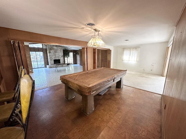 recreation room with a stone fireplace and billiards