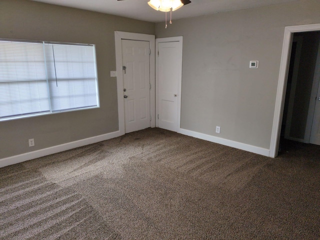 carpeted spare room with ceiling fan