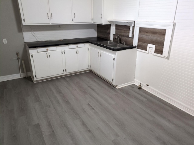 kitchen with white cabinets, decorative backsplash, dark hardwood / wood-style floors, and sink