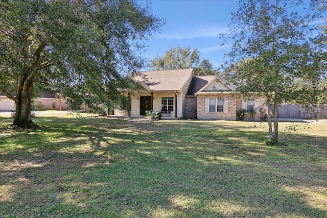 ranch-style home featuring a front yard