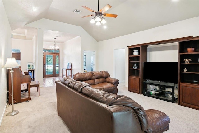 living room featuring french doors, ceiling fan with notable chandelier, light colored carpet, and vaulted ceiling