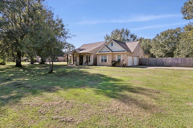 single story home with covered porch, a garage, and a front lawn