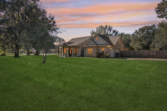 view of front facade featuring a garage and a yard