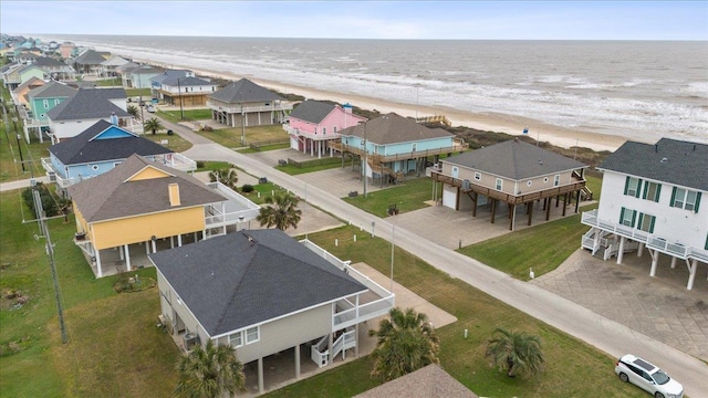 drone / aerial view featuring a water view and a view of the beach