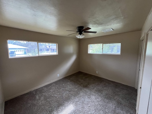 unfurnished room with ceiling fan, a textured ceiling, and a wealth of natural light