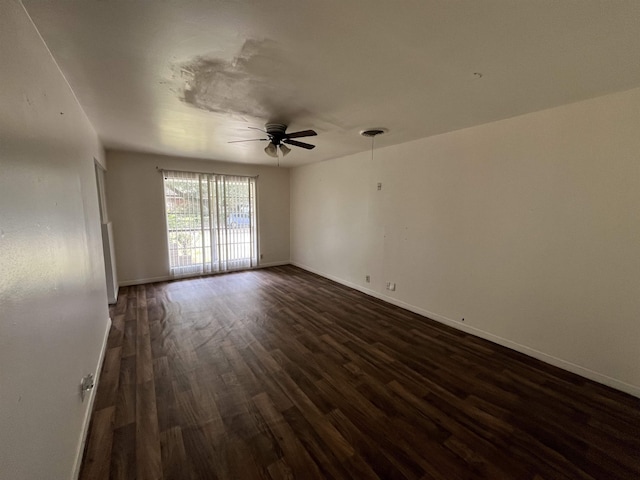 unfurnished room featuring dark hardwood / wood-style floors and ceiling fan