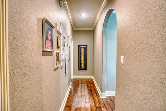 hall with dark wood-type flooring and ornamental molding