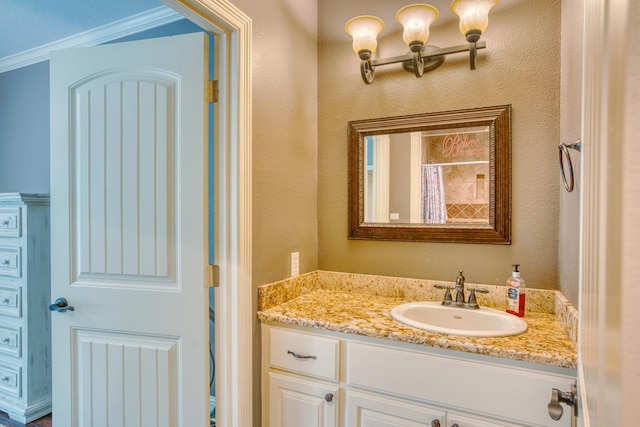 bathroom with curtained shower, crown molding, and vanity