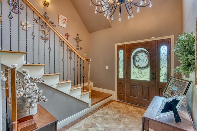 tiled foyer entrance featuring high vaulted ceiling and an inviting chandelier