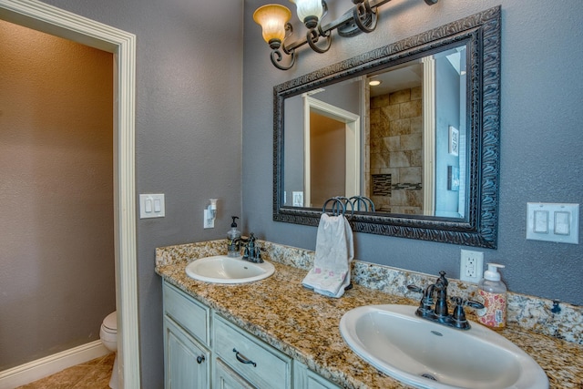 bathroom featuring tile patterned flooring, vanity, and toilet