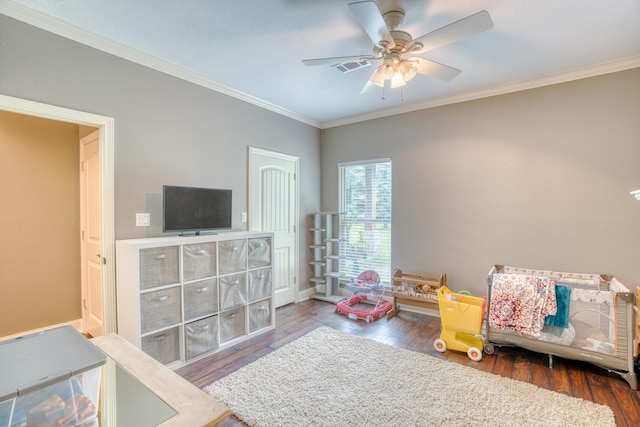 bedroom featuring dark hardwood / wood-style flooring, ceiling fan, and crown molding