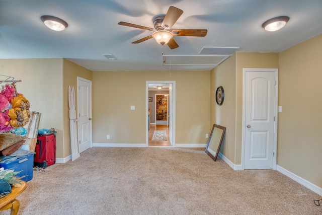 carpeted spare room featuring ceiling fan