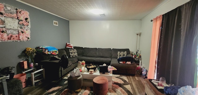 living room with hardwood / wood-style flooring and ornamental molding