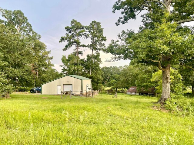 view of yard with a garage and an outdoor structure