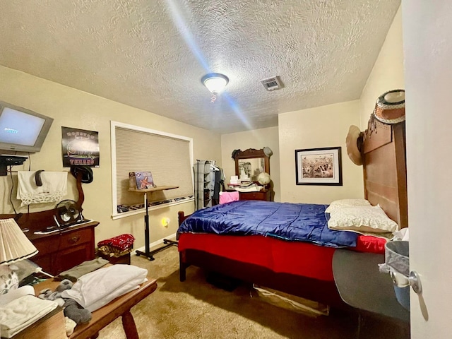 bedroom with light carpet and a textured ceiling