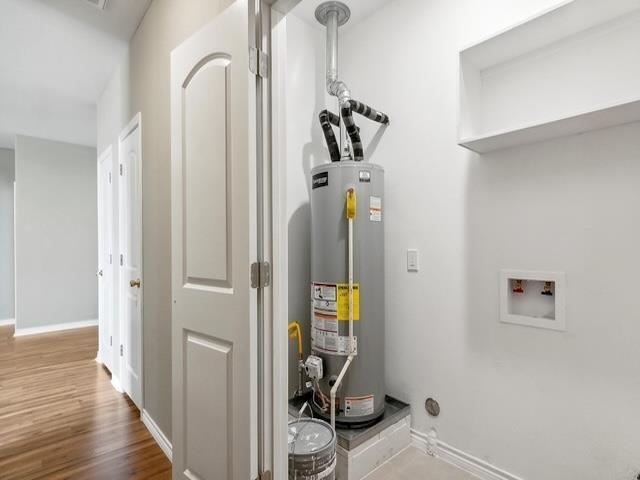 utility room featuring gas water heater