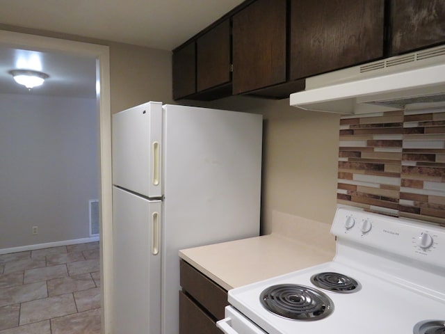 2345 Nall St, Port Neches, TX 77651 - kitchen with white appliances, light countertops, dark brown cabinets, under cabinet range hood, and baseboards