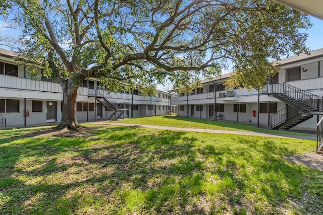 2345 Nall St, Port Neches, TX 77651 - surrounding community featuring stairway and a yard
